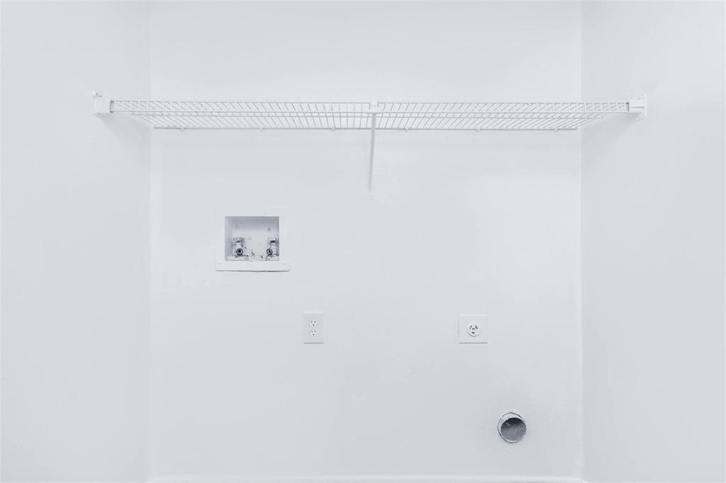 1826 Esters Road, Unit 1050 Irving, TX 75061 - Photo 31 of 39 Wall-mounted wire shelving, utility hook-ups, and a dryer vent
