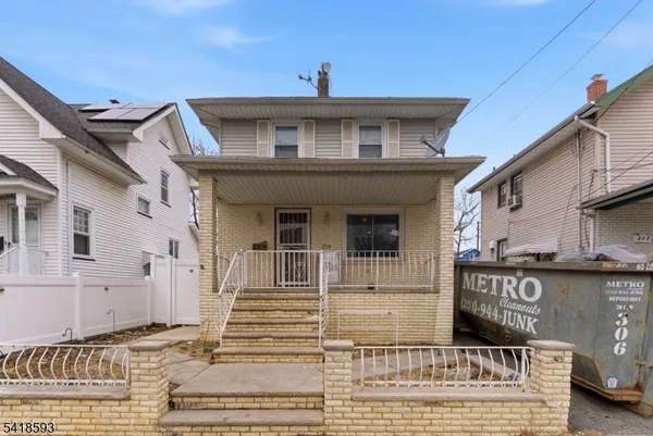 a living room with furniture and a flat screen tv with a bookshelf