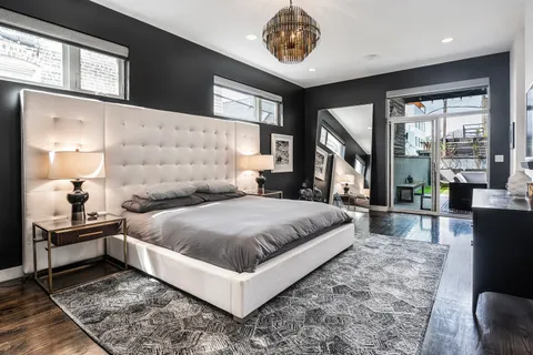 a bedroom with a large bed and a large window