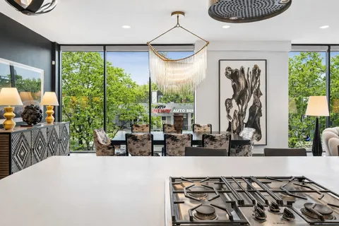a kitchen with a large window and dining table