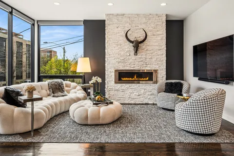 a living room with furniture kitchen view and a fireplace