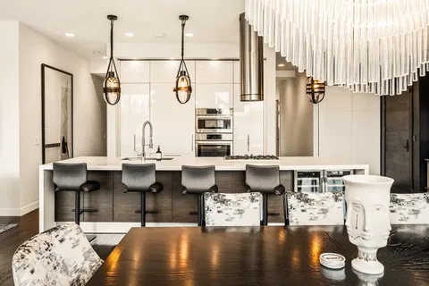 a kitchen with a table chairs stove and kitchen view