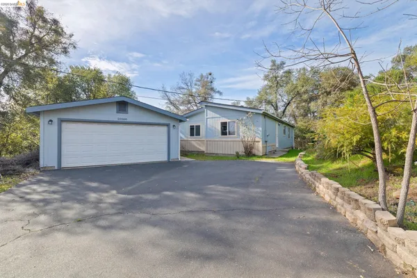 a view of house with backyard and road