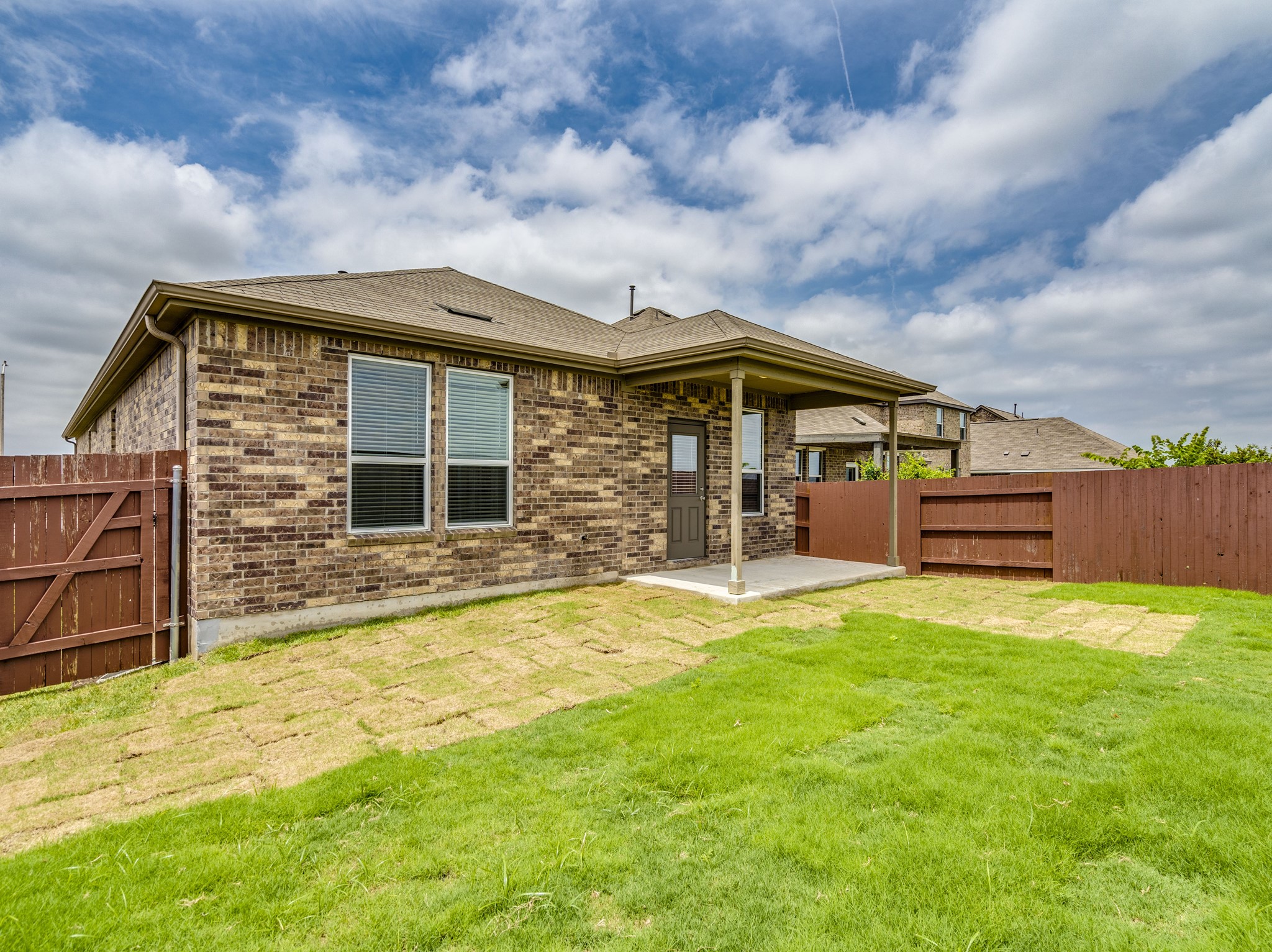 790 Pepperbark Loop Buda, TX 78610 - Photo 19 of 22 A spacious backyard with fresh sod offers a covered patio for outdoor enjoyment.