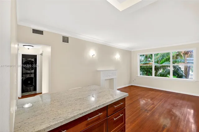 a view of a kitchen with granite countertop cabinets and a wooden floor