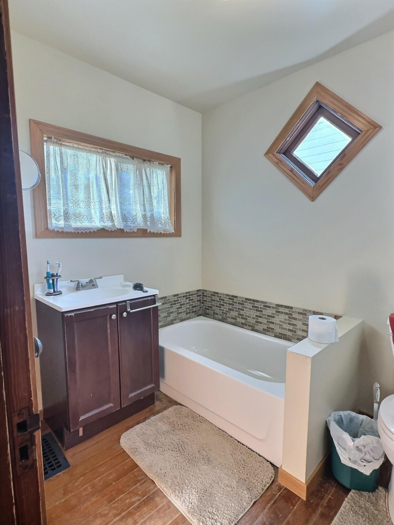 136 East Main Street Brook, IN 47922 - Photo 11 of 25 a bathroom with a tub toilet and sink