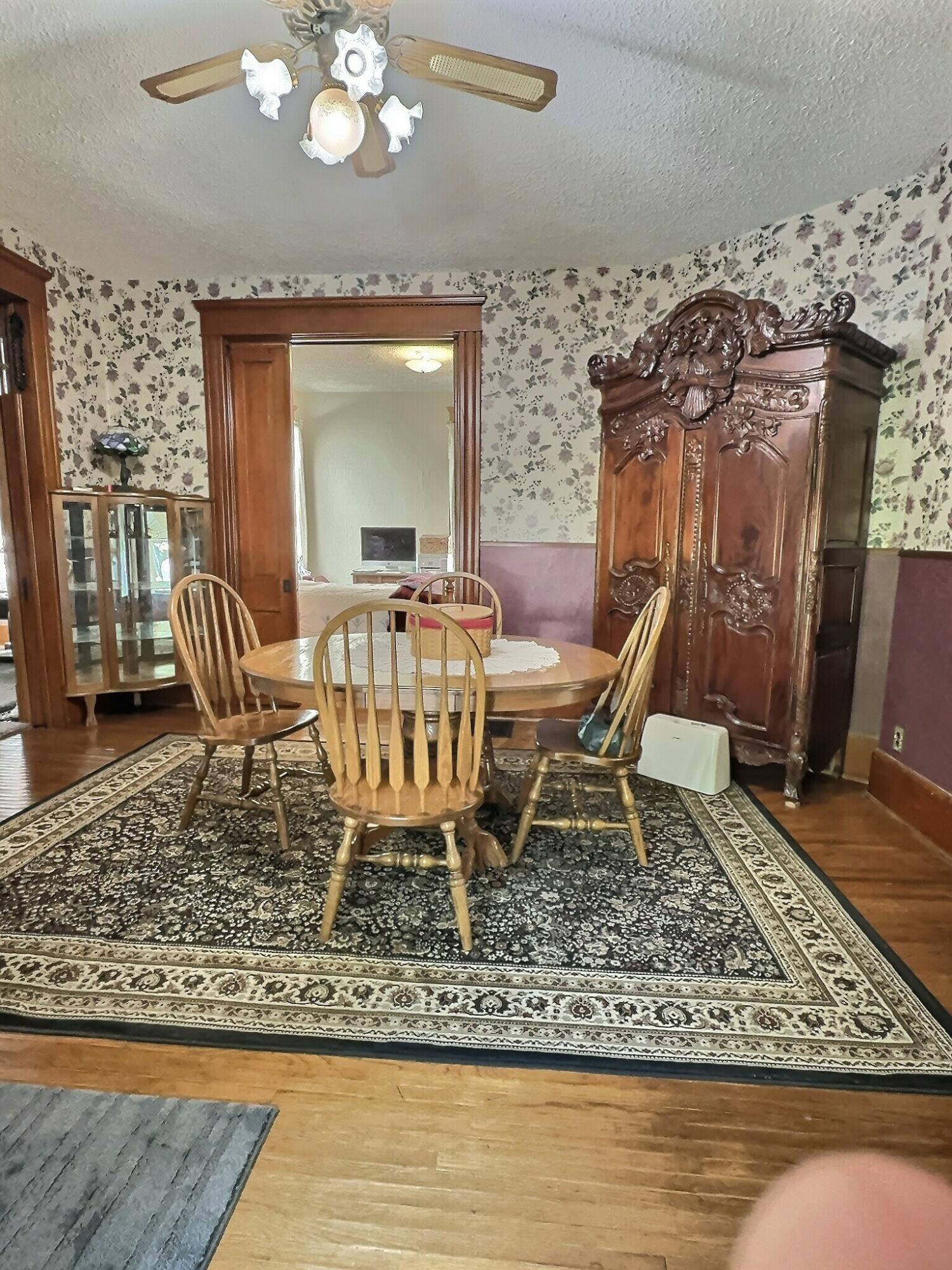 136 East Main Street Brook, IN 47922 - Photo 16 of 25 a view of a dining room with furniture wooden floor and a rug
