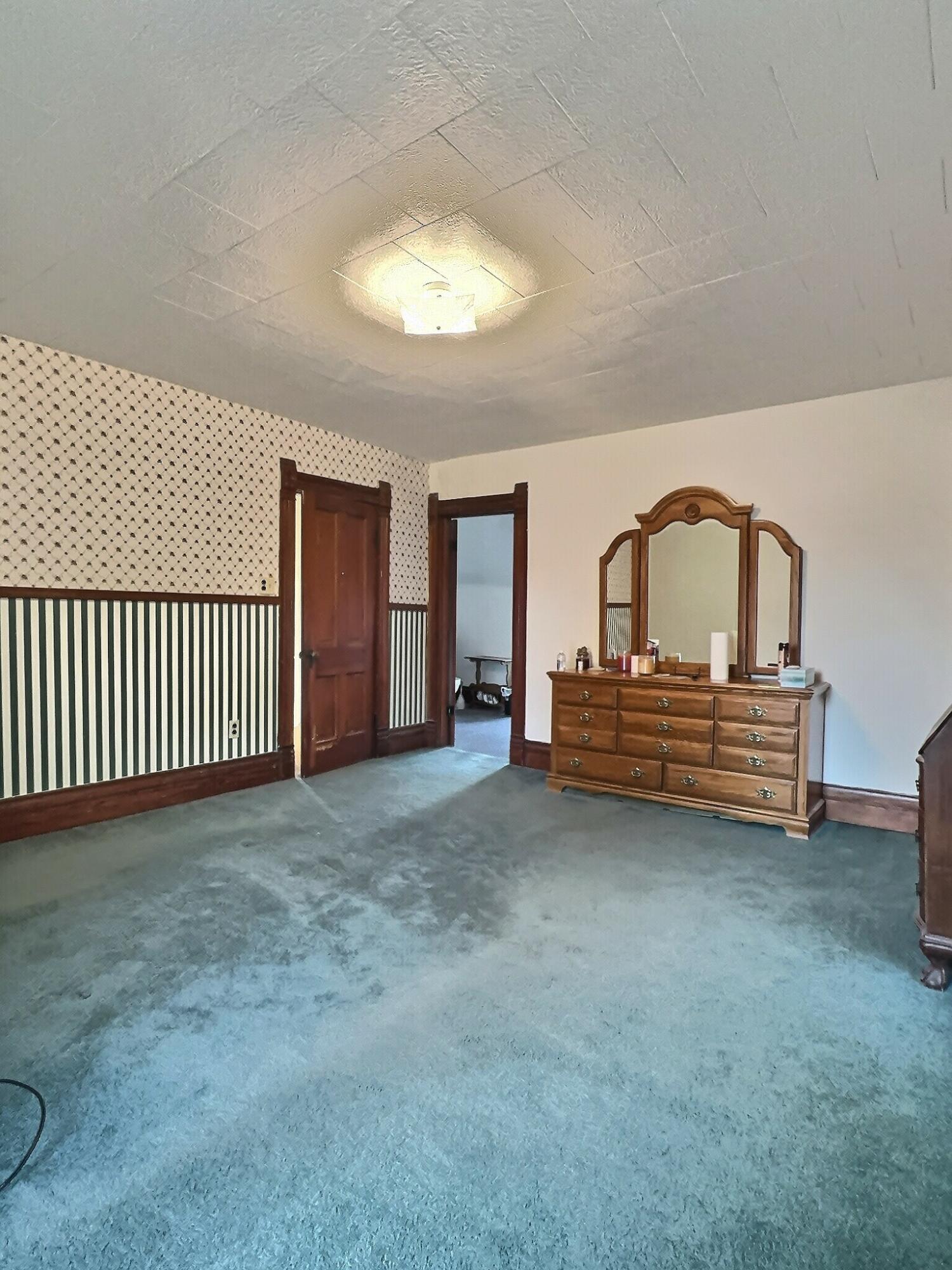 136 East Main Street Brook, IN 47922 - Photo 21 of 25 a view of a room with stairs and a chandelier