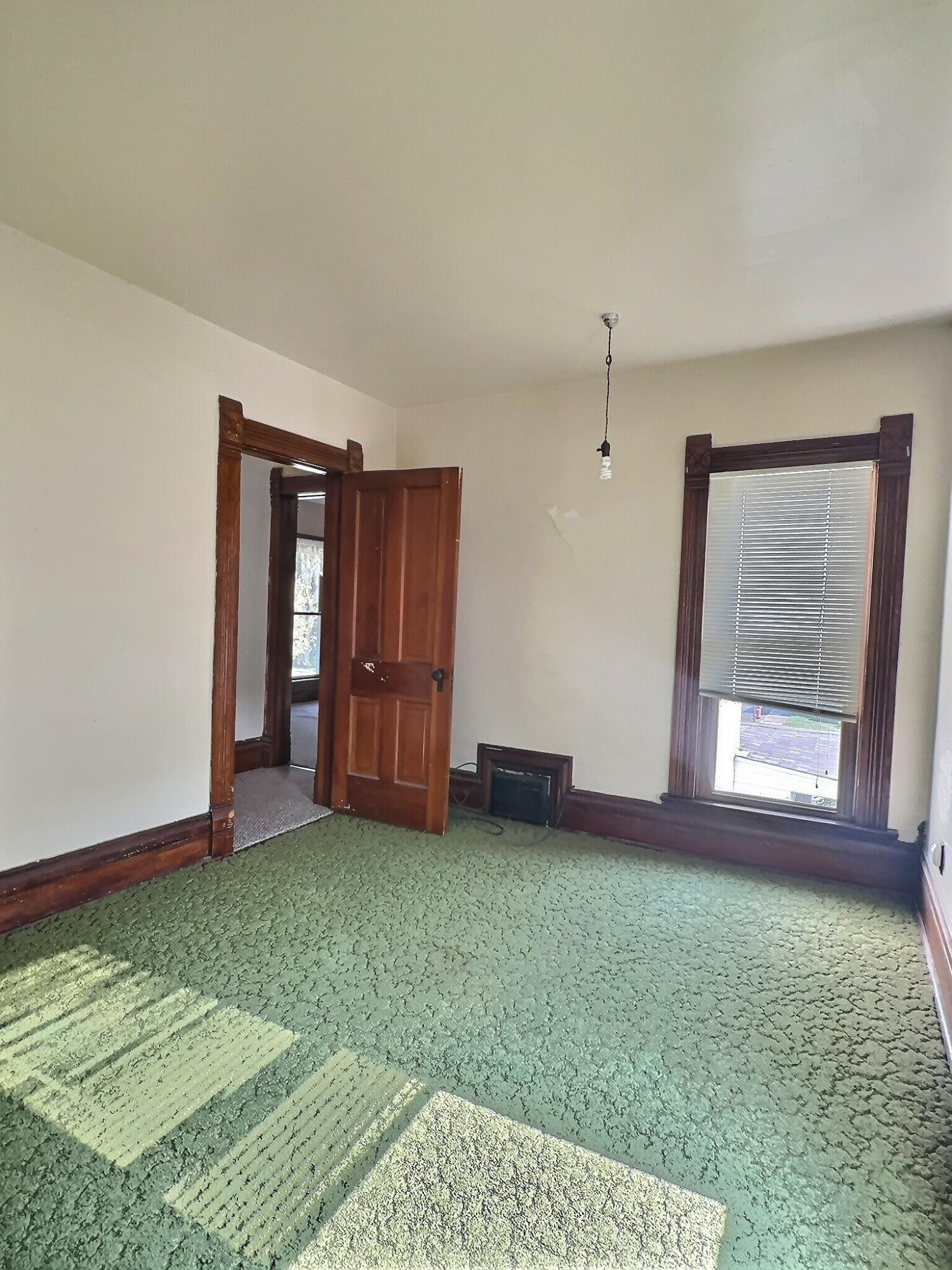 136 East Main Street Brook, IN 47922 - Photo 23 of 25 a view of an empty room with window and wooden floor