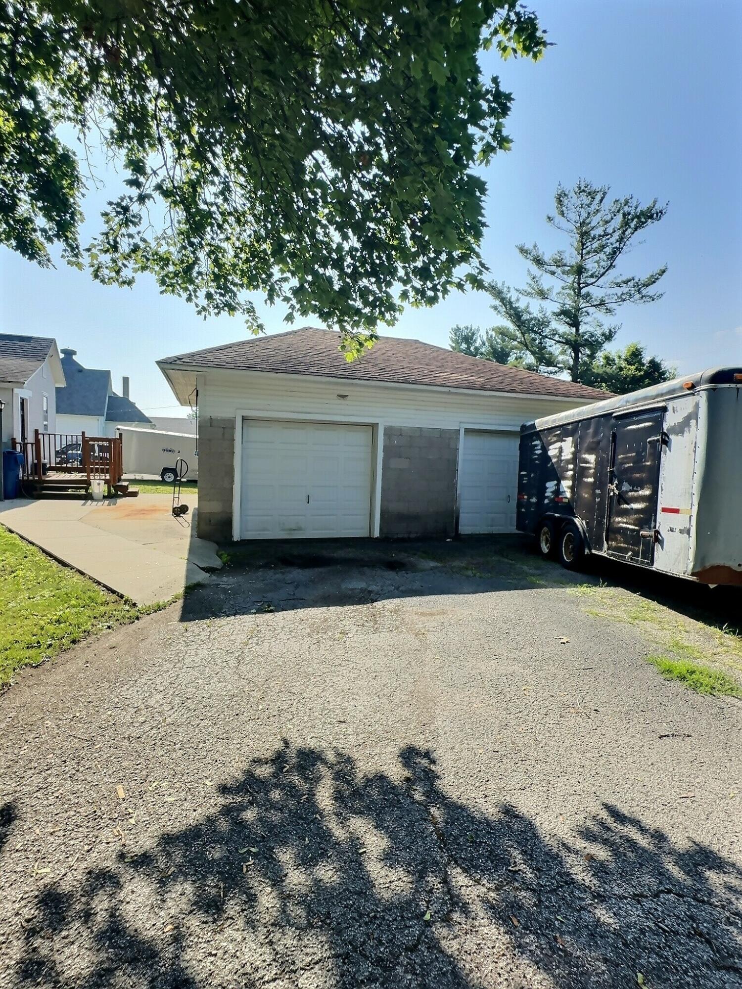 136 East Main Street Brook, IN 47922 - Photo 3 of 25 a view of a house with a yard and garage