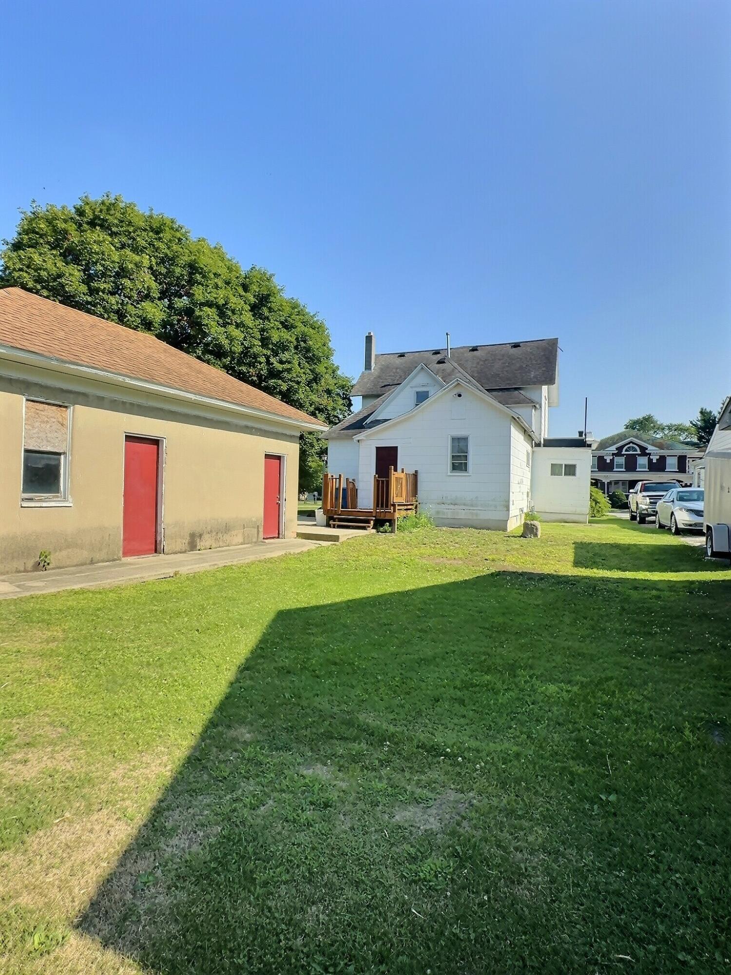 136 East Main Street Brook, IN 47922 - Photo 4 of 25 a front view of house with yard and trees