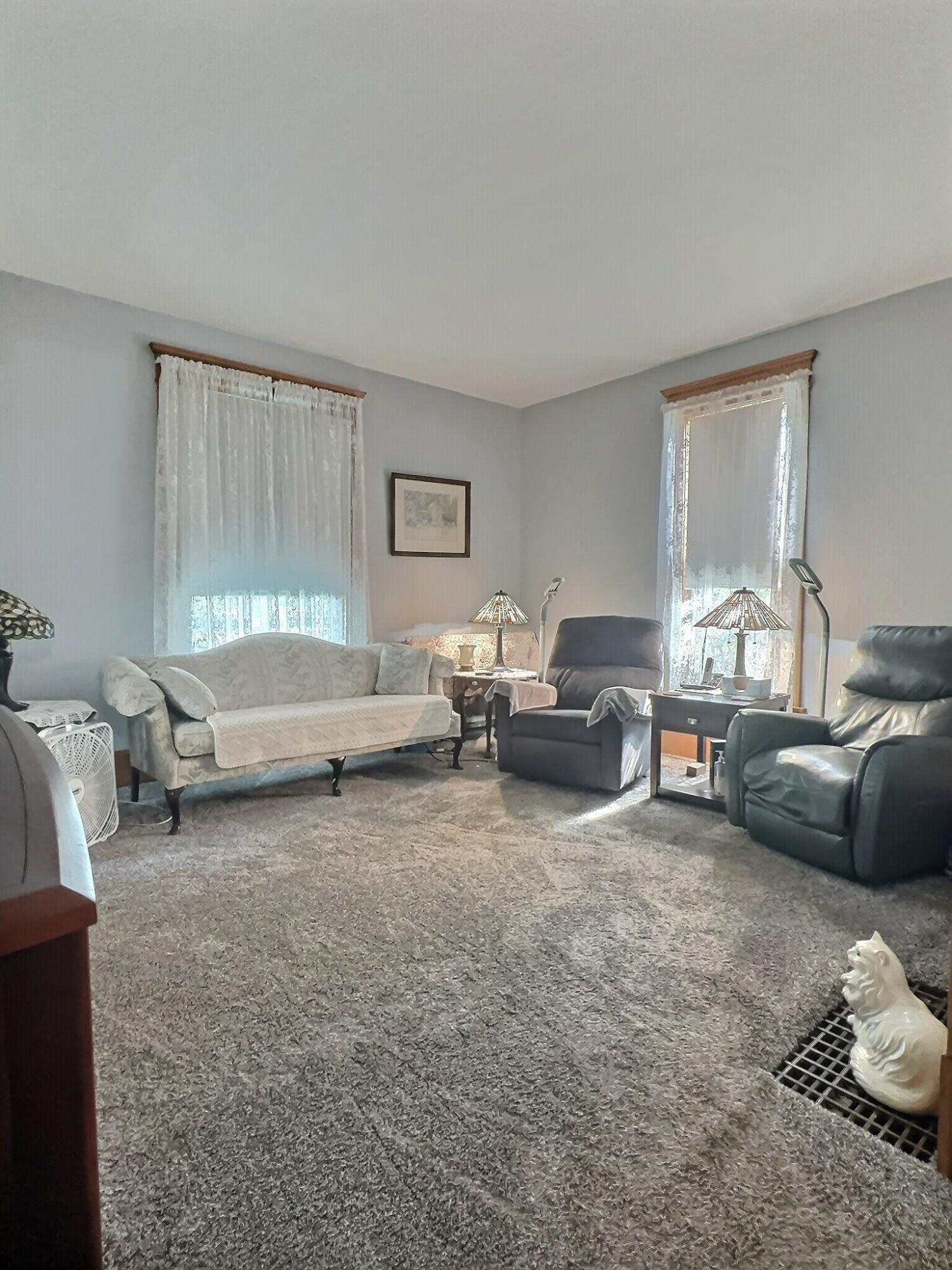 136 East Main Street Brook, IN 47922 - Photo 6 of 25 a living room with furniture and a window