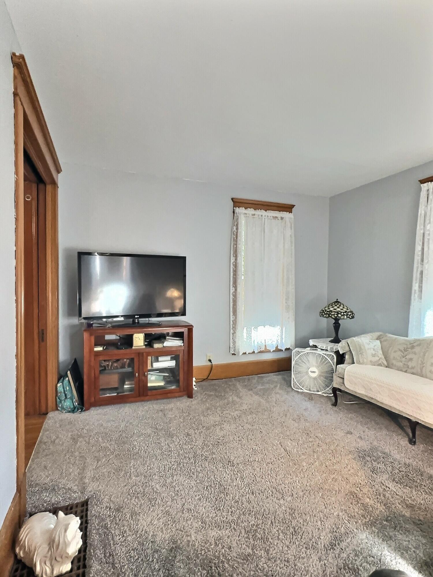 136 East Main Street Brook, IN 47922 - Photo 8 of 25 a living room with furniture and a flat screen tv