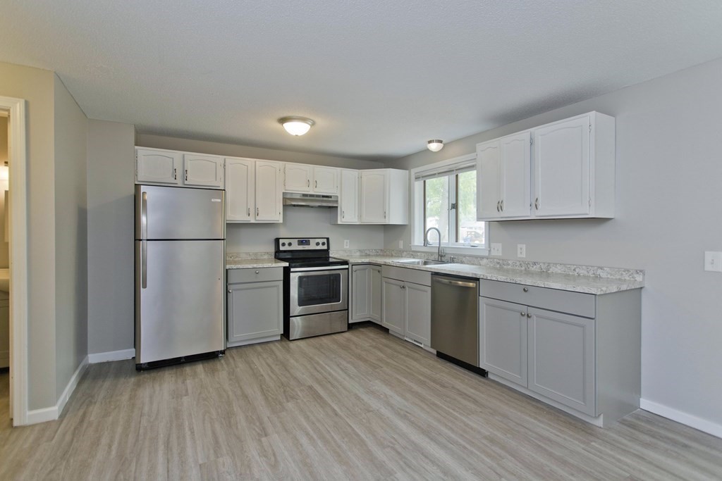108 Odion Avenue Springfield, MA 01118 - Photo 2 of 24 a kitchen with a refrigerator a sink and dishwasher with wooden floor