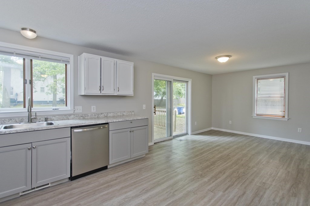 108 Odion Avenue Springfield, MA 01118 - Photo 5 of 24 a kitchen with granite countertop wooden floors a sink and dishwasher with wooden floor