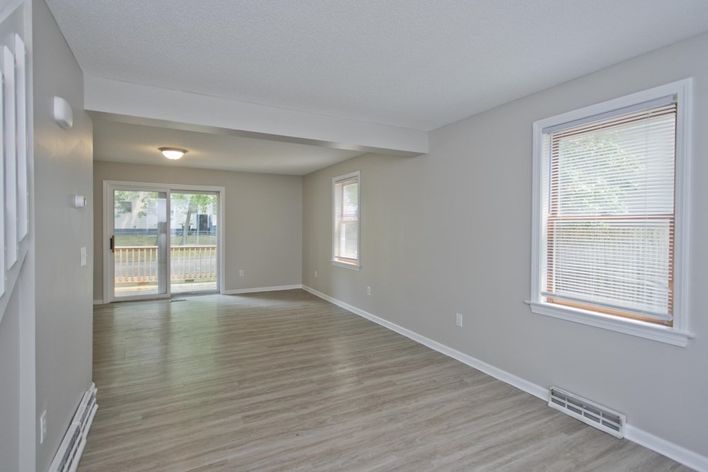 108 Odion Avenue Springfield, MA 01118 - Photo 9 of 24 a view of an empty room with wooden floor and windows