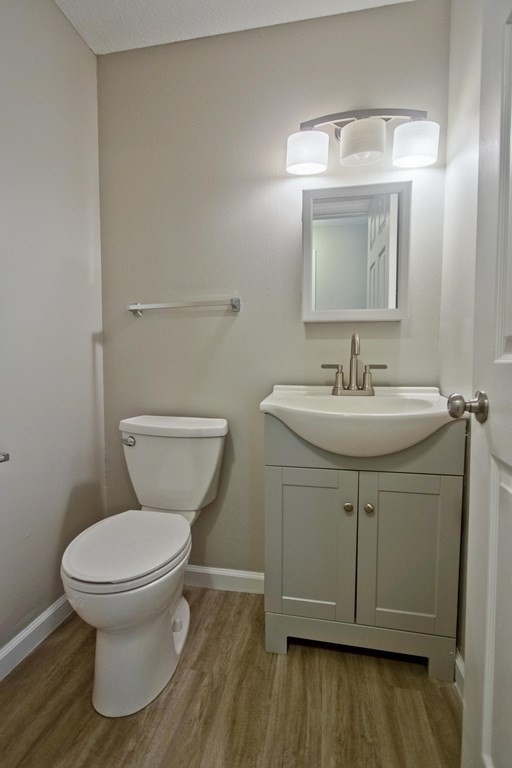 108 Odion Avenue Springfield, MA 01118 - Photo 10 of 24 a bathroom with a toilet sink and mirror