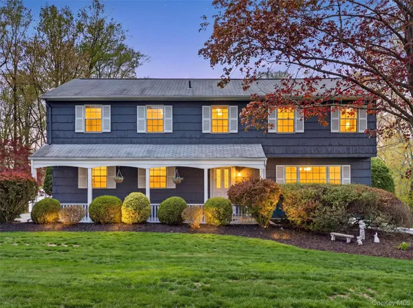 a view of a brick house with a yard