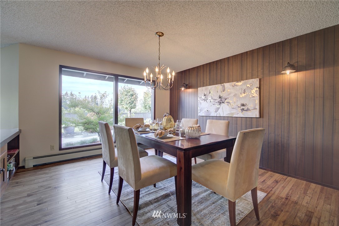 19415 Southeast 141st Street Renton, WA 98059 - Photo 15 of 39 a dining room with furniture a chandelier and wooden floor