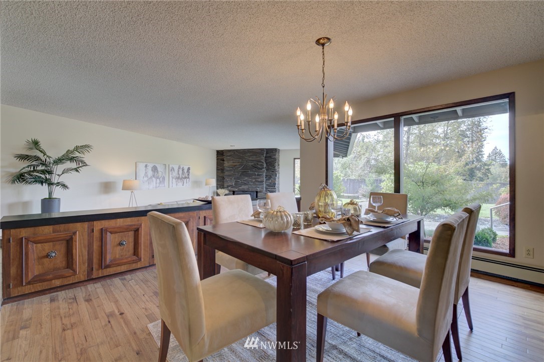 19415 Southeast 141st Street Renton, WA 98059 - Photo 16 of 39 a dining room with furniture a chandelier and wooden floor