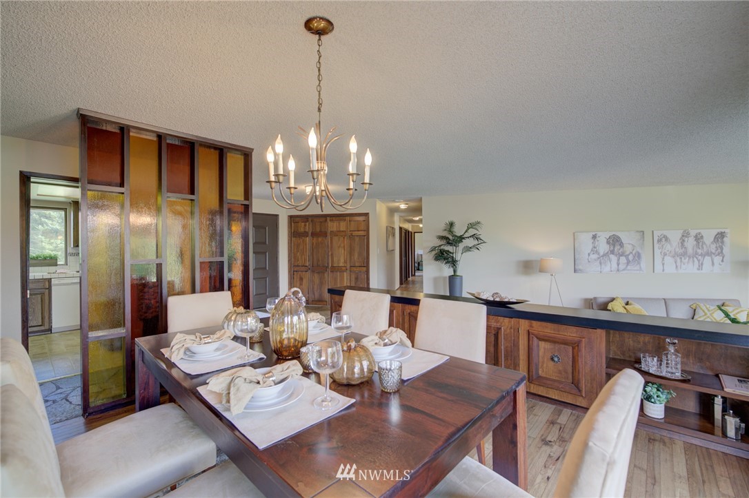 19415 Southeast 141st Street Renton, WA 98059 - Photo 17 of 39 a view of a dining room with furniture wooden floor and chandelier