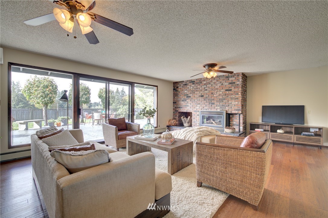 19415 Southeast 141st Street Renton, WA 98059 - Photo 18 of 39 a living room with fireplace furniture and a large window