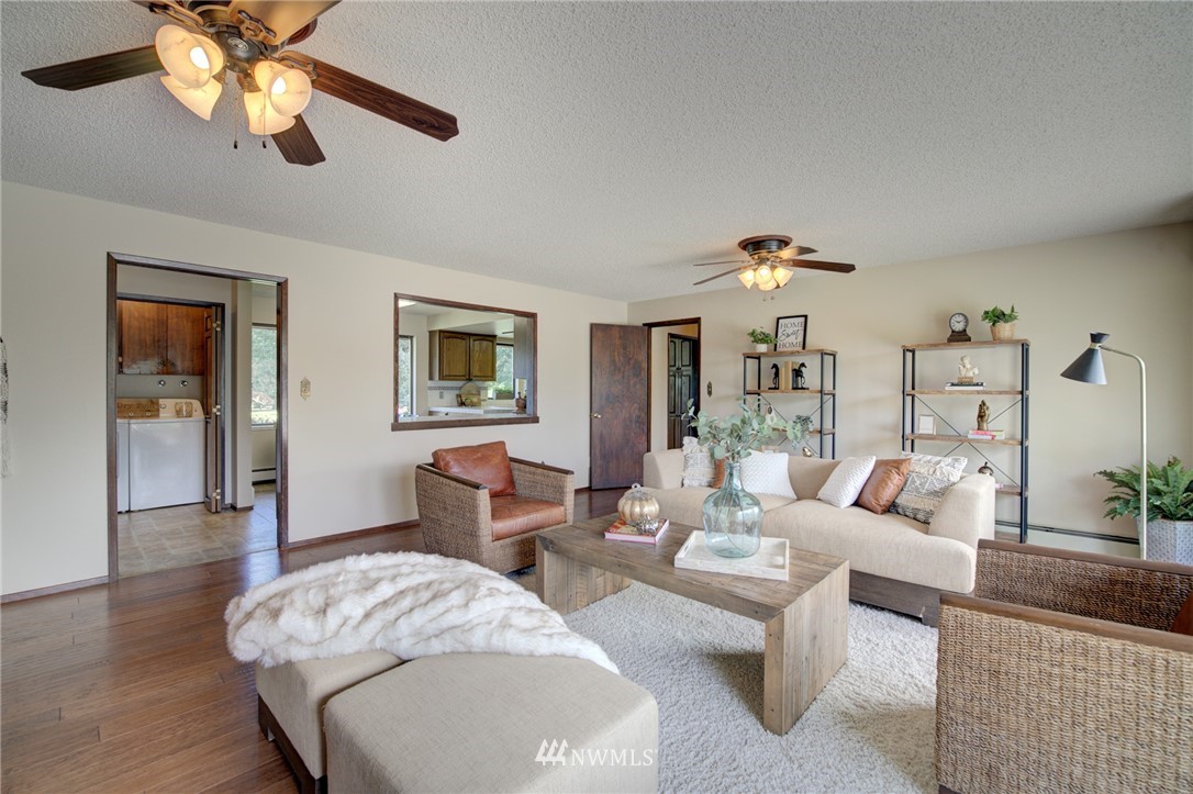 19415 Southeast 141st Street Renton, WA 98059 - Photo 20 of 39 a living room with furniture a chandelier fan and a window