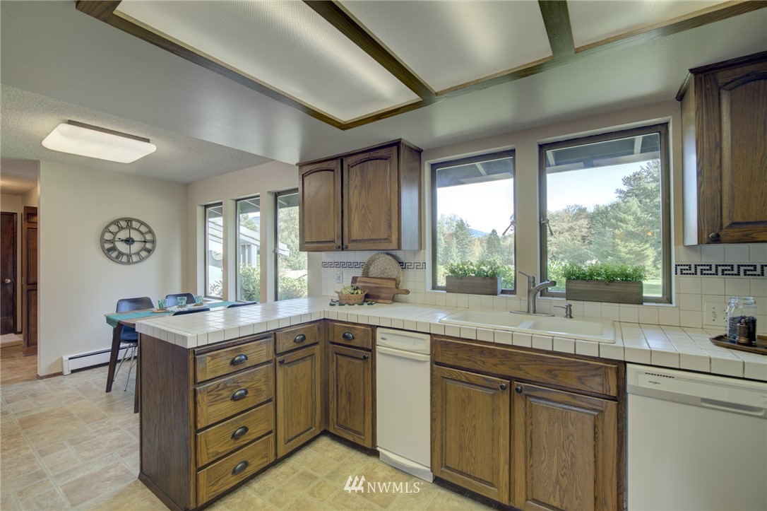 19415 Southeast 141st Street Renton, WA 98059 - Photo 25 of 39 a kitchen with a sink stove and cabinets