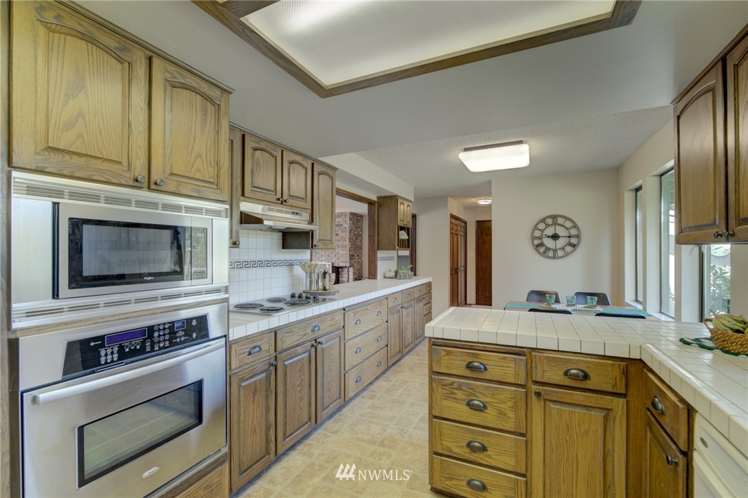 19415 Southeast 141st Street Renton, WA 98059 - Photo 26 of 39 a kitchen with stainless steel appliances granite countertop a sink and cabinets