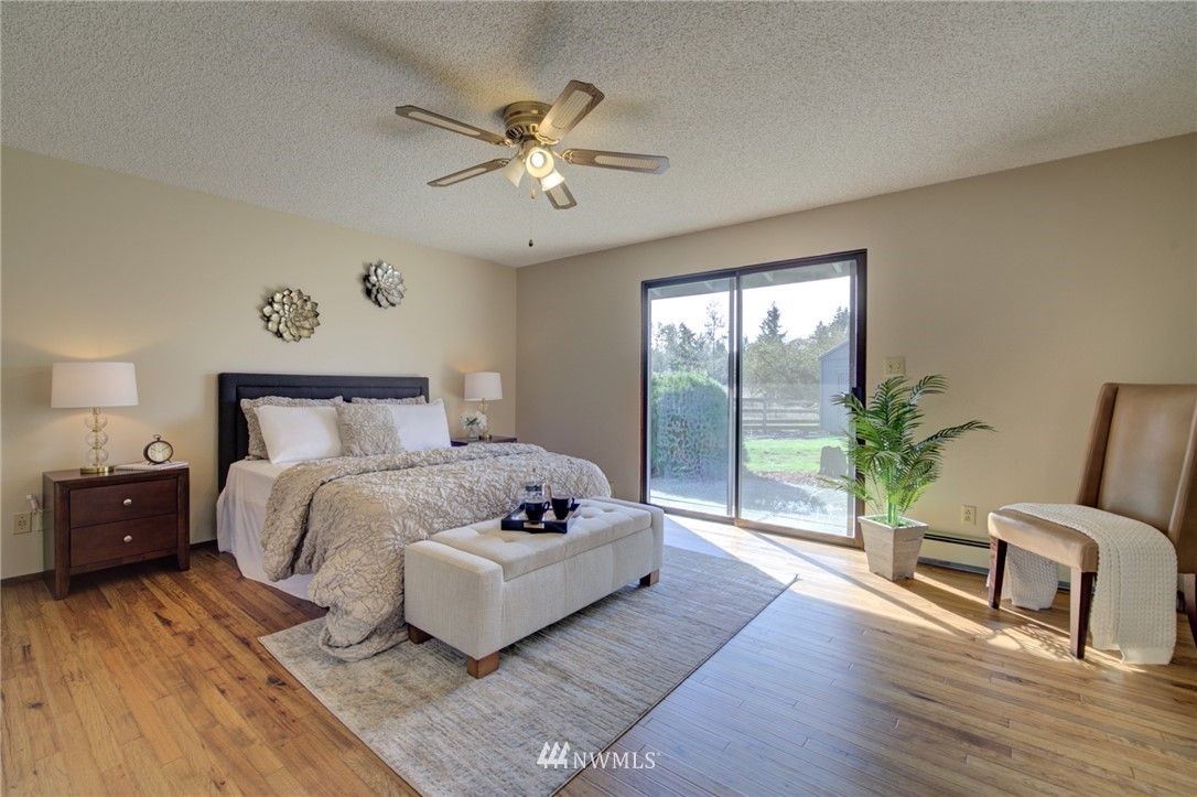 19415 Southeast 141st Street Renton, WA 98059 - Photo 28 of 39 a bedroom with a bed and a chandelier
