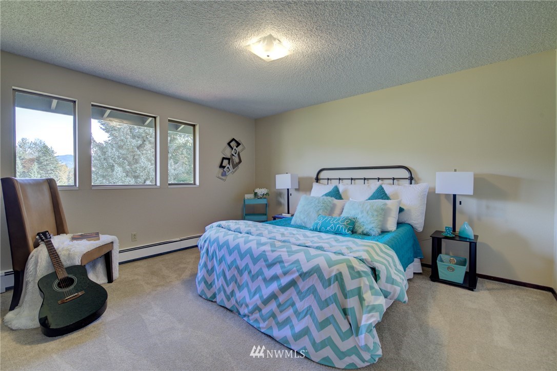19415 Southeast 141st Street Renton, WA 98059 - Photo 32 of 39 a bedroom with a bed and furniture