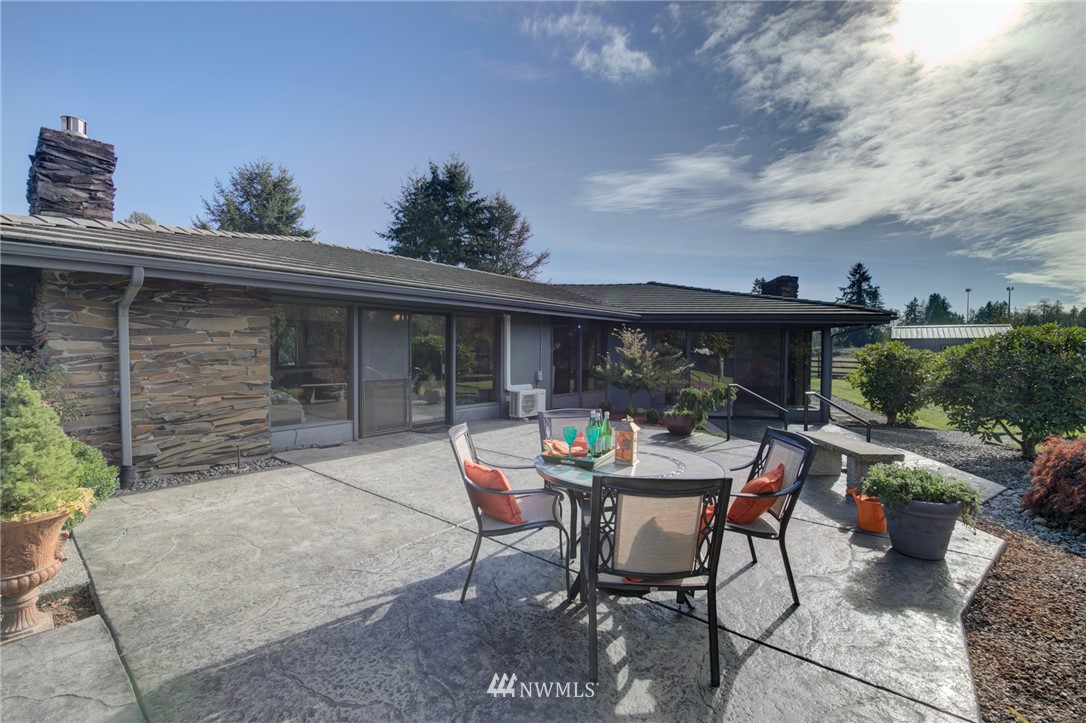 19415 Southeast 141st Street Renton, WA 98059 - Photo 37 of 39 a view of a patio with table and chairs and potted plants