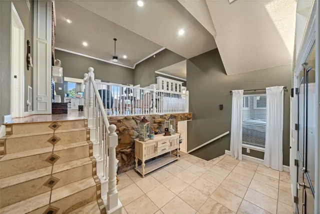 a view of a dining room and livingroom with furniture wooden floor a chandelier