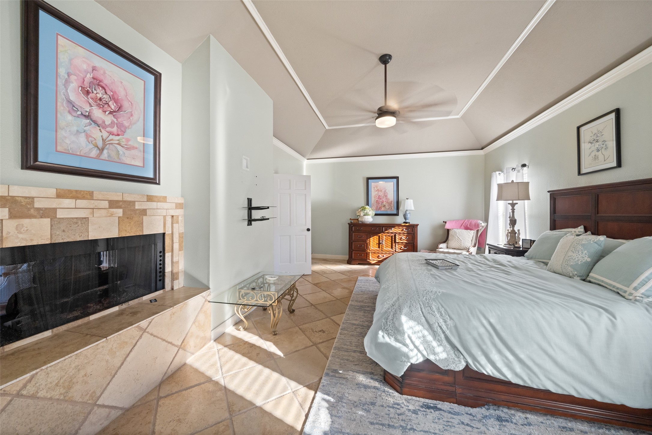 8314 Atascocita Lake Way Humble, TX 77346 - Photo 13 of 47 a spacious bedroom with a bed and a fireplace