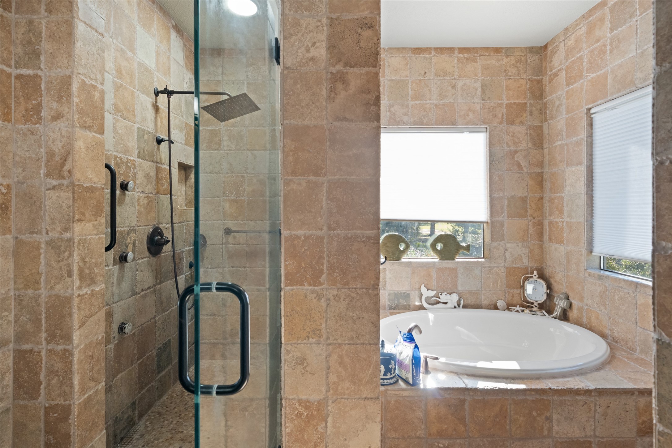 8314 Atascocita Lake Way Humble, TX 77346 - Photo 14 of 47 a bathroom with a white bath tub a shower and a sink