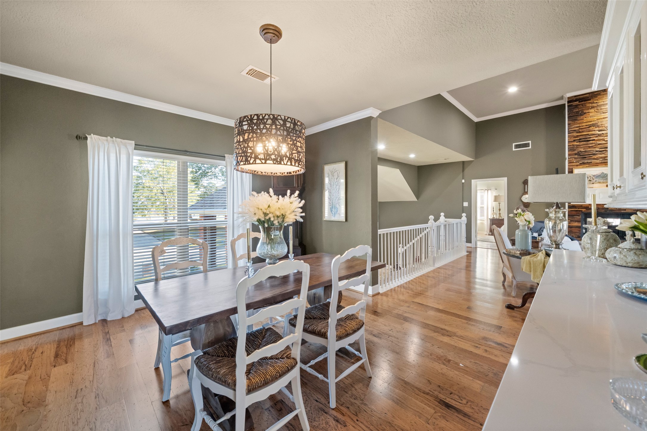 8314 Atascocita Lake Way Humble, TX 77346 - Photo 18 of 47 a view of a dining room and livingroom with furniture wooden floor a chandelier