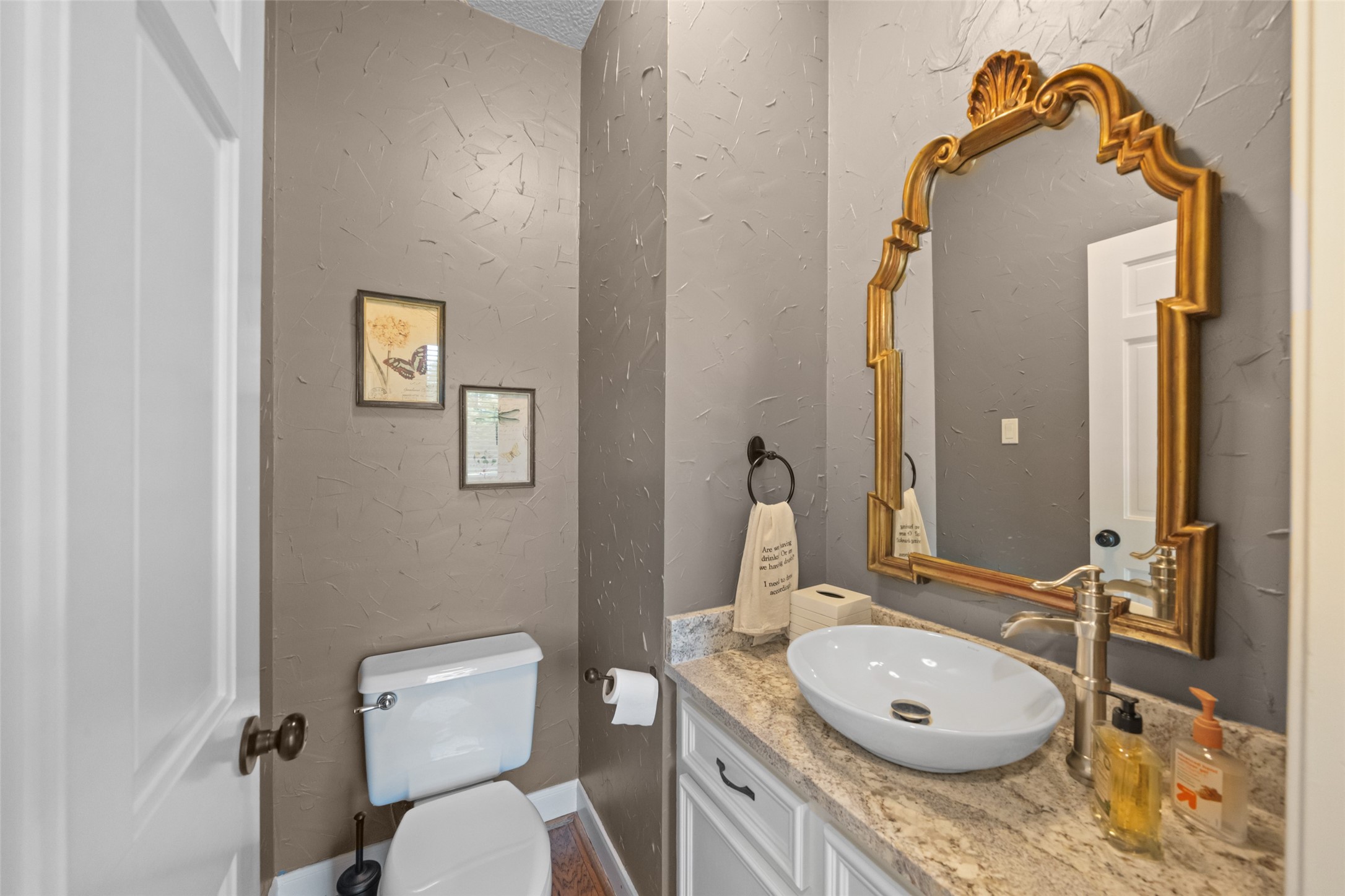 8314 Atascocita Lake Way Humble, TX 77346 - Photo 29 of 47 a bathroom with a granite countertop toilet sink and mirror