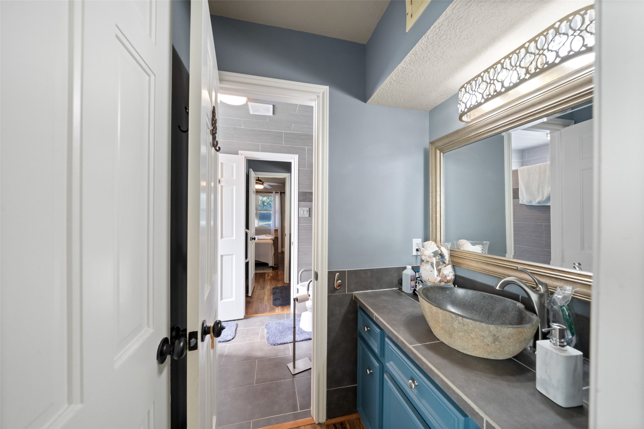 8314 Atascocita Lake Way Humble, TX 77346 - Photo 35 of 47 a bathroom with a granite countertop sink a mirror and shower