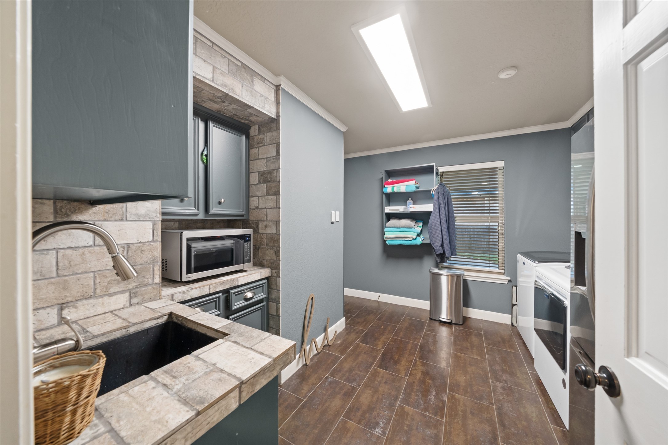 8314 Atascocita Lake Way Humble, TX 77346 - Photo 39 of 47 a kitchen with stainless steel appliances kitchen island granite countertop a stove a sink and a microwave