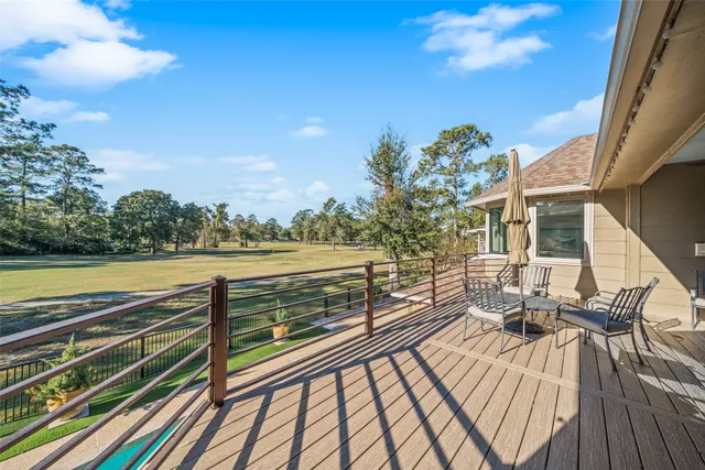 a bedroom with a large bed a rug and couch