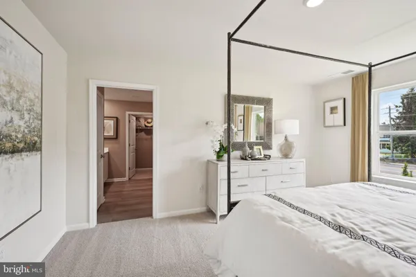 a bedroom with a bed and a dresser