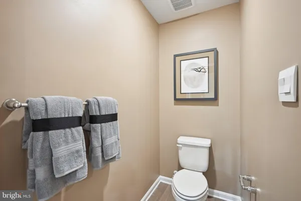 a white toilet sitting next to a bathroom sink