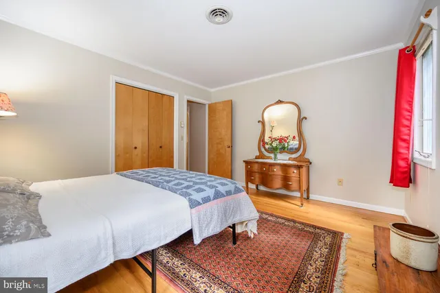 a bedroom with a bed and a dresser