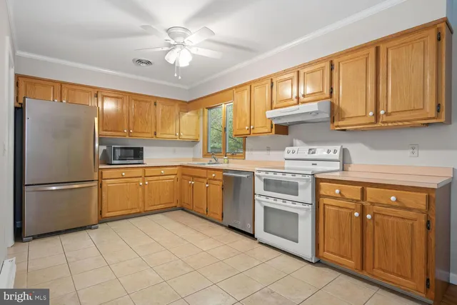a kitchen with stainless steel appliances granite countertop a refrigerator sink and cabinets