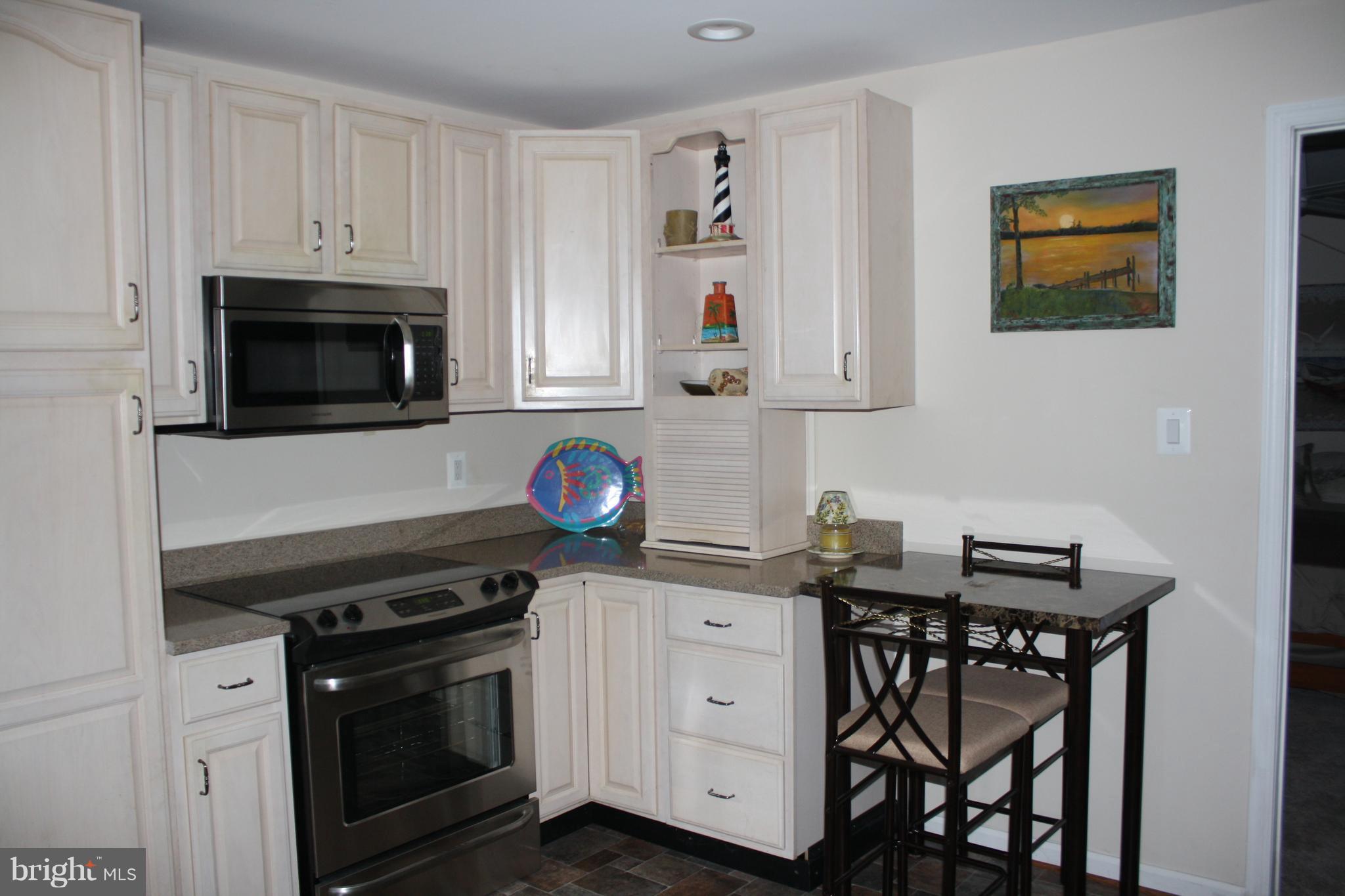 148 Ruth Court Strasburg, VA 22657 - Photo 23 of 30 a kitchen with stainless steel appliances a stove microwave and cabinets