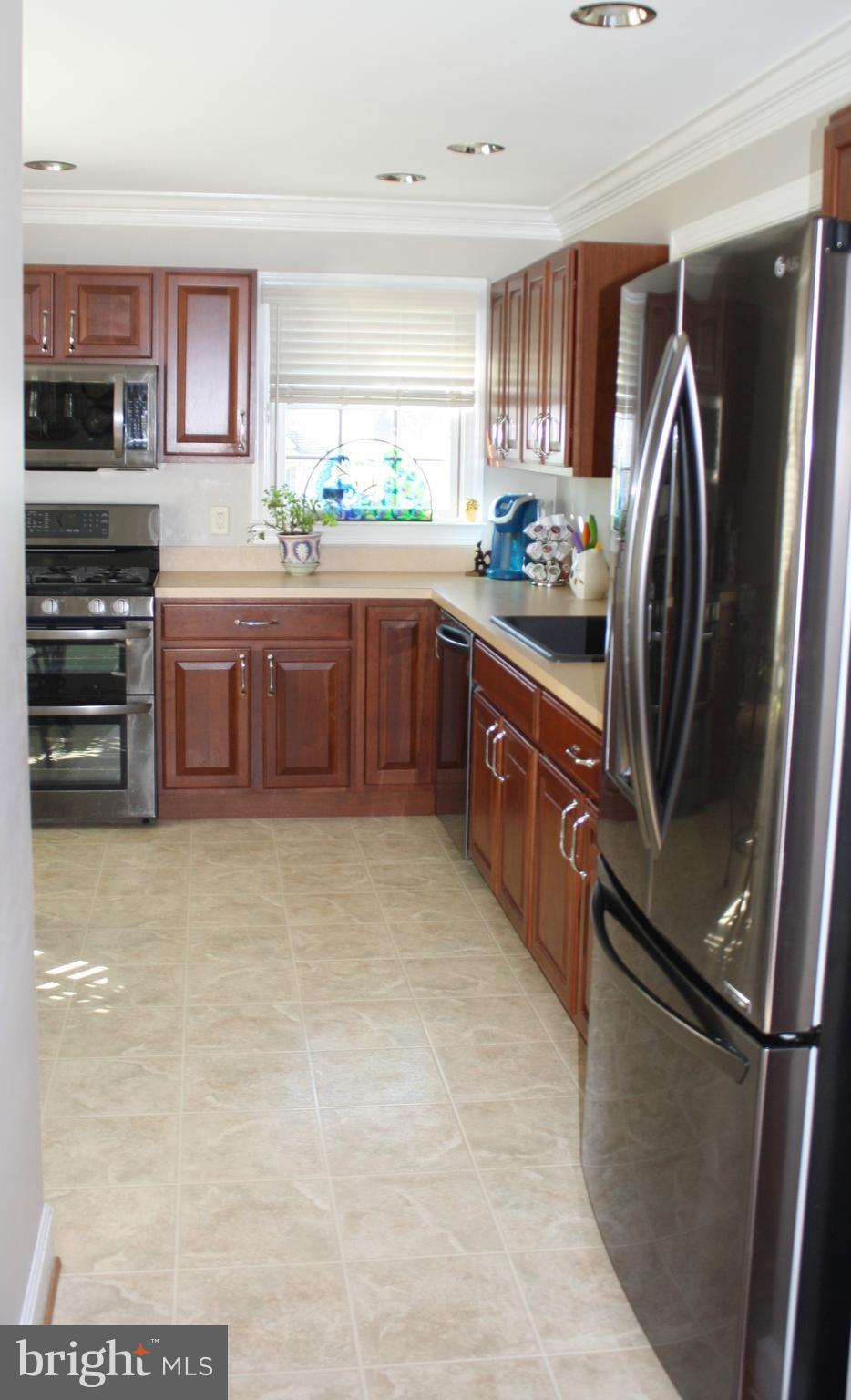 148 Ruth Court Strasburg, VA 22657 - Photo 5 of 30 a kitchen with stainless steel appliances a refrigerator a sink a stove and cabinets