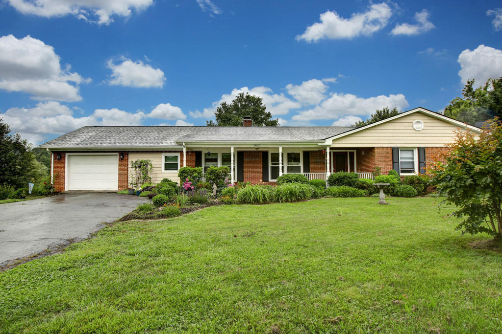 1400 Morgans Mill Road Goodview, VA 24095 - Photo 1 of 21 a front view of a house with garden