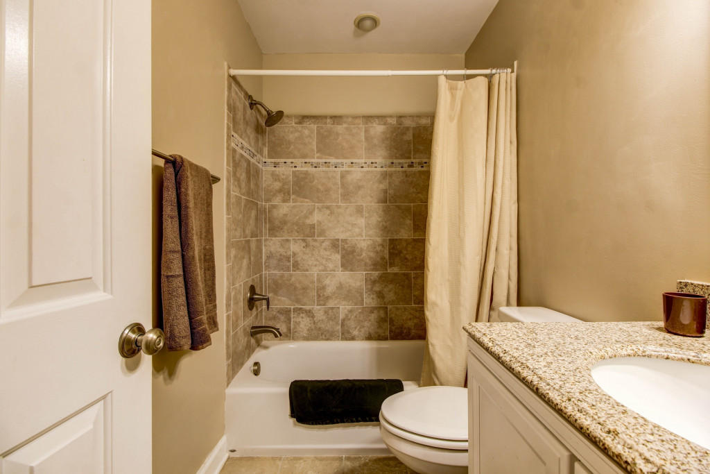 1400 Morgans Mill Road Goodview, VA 24095 - Photo 13 of 21 a bathroom with a granite countertop sink toilet and shower
