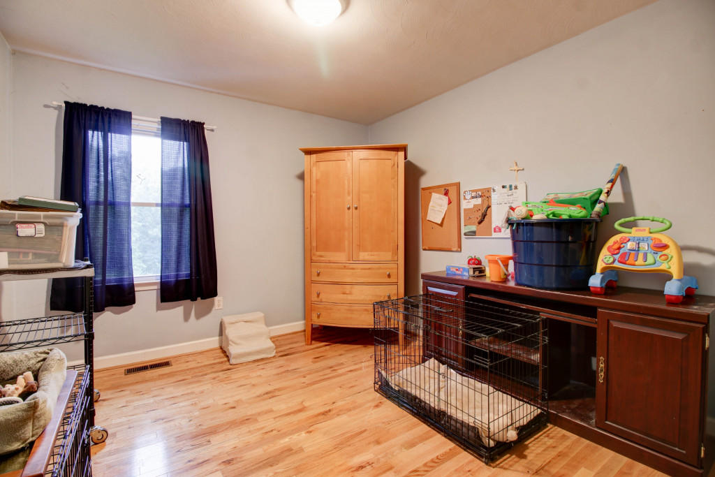 1400 Morgans Mill Road Goodview, VA 24095 - Photo 16 of 21 a living room with furniture and wooden floor