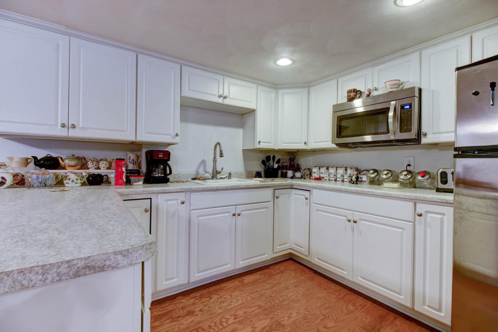 1400 Morgans Mill Road Goodview, VA 24095 - Photo 17 of 21 a kitchen with stainless steel appliances granite countertop a sink a stove and cabinets